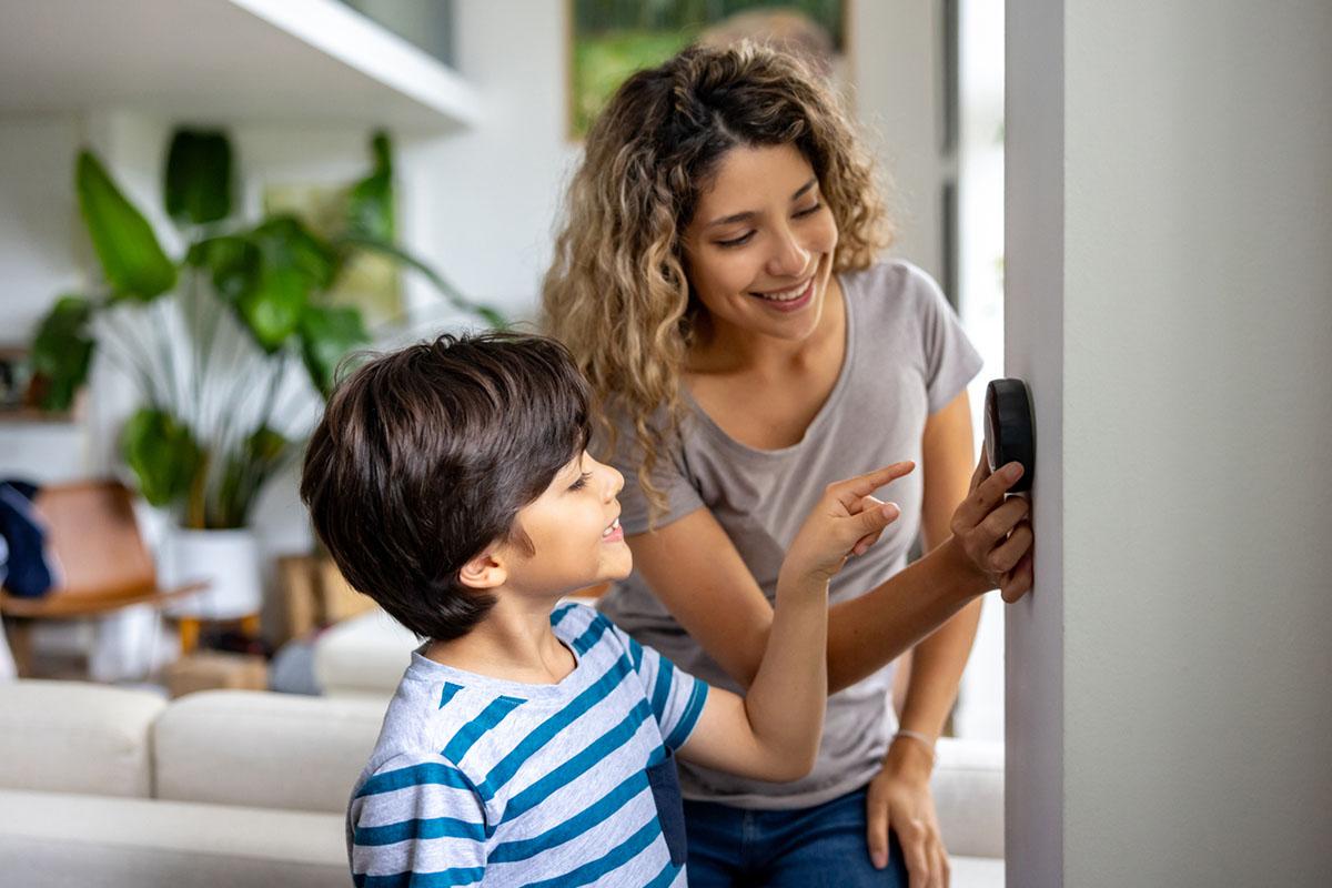 woman and child looking at thermostat