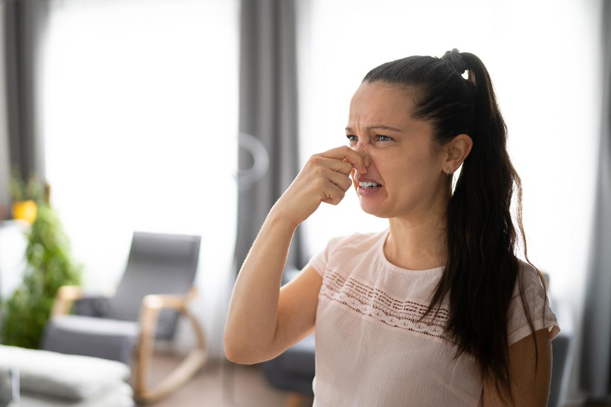 woman pinching her nose